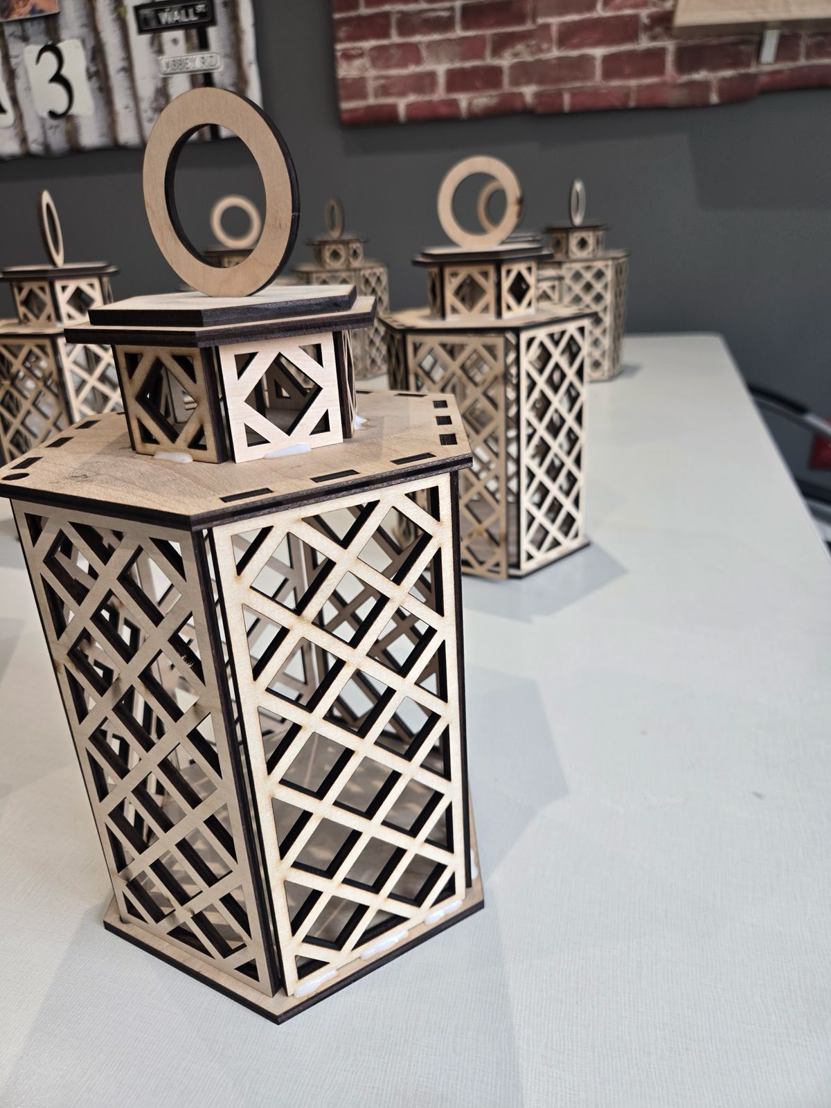 Actual unpainted laser-cut plywood lantern with lattice sides and a ring handle
