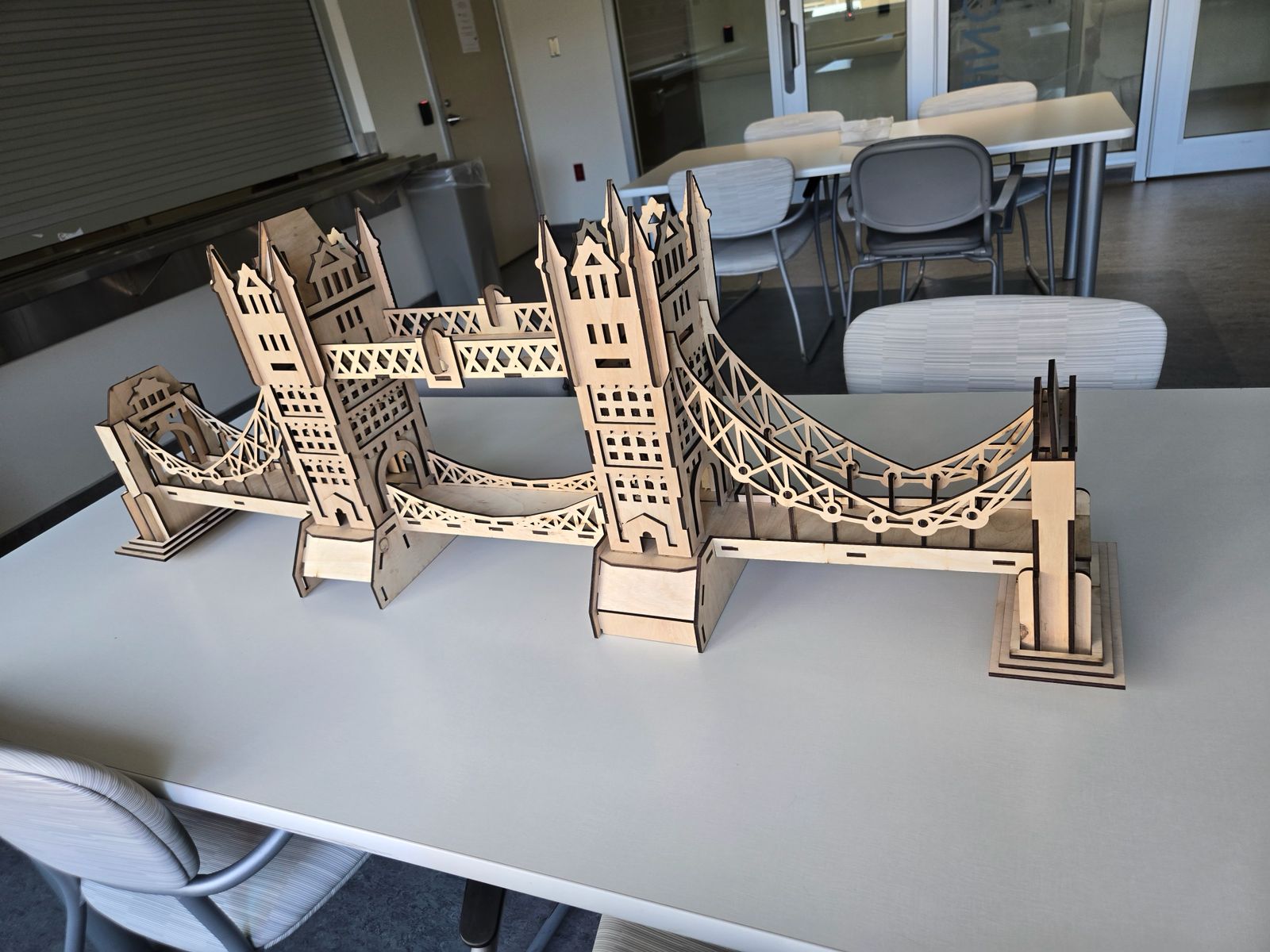 Actual unpainted plywood London Bridge model with two towers and laser-cut bridge spans